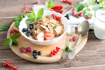 Ingredients tasty healthy breakfast for cooking with milk. Healthy tasty breakfast multigrain wholewheat healthy cereals with strawberries, raspberries, black currants and red currants.