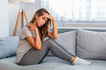 Young woman suffering from pain in shoulder. People, healthcare and problem concept - unhappy woman...