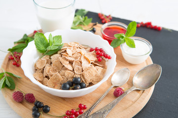 Healthy breakfast on the table close up Healthy tasty breakfast multigrain wholewheat healthy cereals with strawberries, raspberries, black currants and red currants.