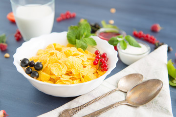 bowl of granola with yogurt and berries isolated on white background, top view Healthy tasty breakfast cornflakes with strawberries, raspberries, black currants and red currants.