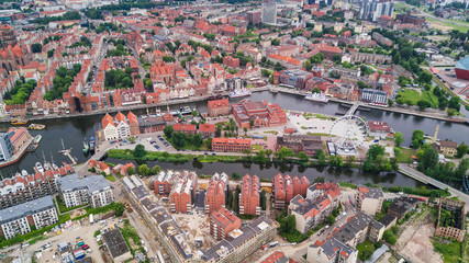 Gdansk, Poland. Aerial skyline panorama with Motlawa river, modern drawbridge, concert hall and all famous monuments in the background