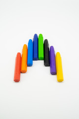 School supplies, colourful crayons stationery on white background - space for caption