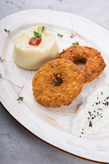 Breaded meat cutlet served with garnish