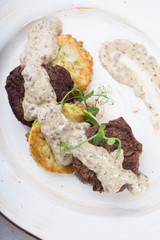 Fried meat cutlet served with sauce