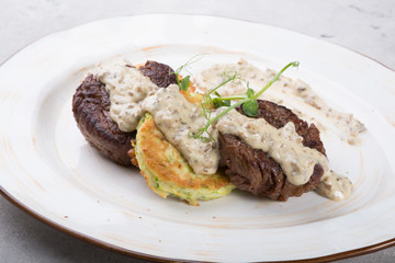 Fried meat cutlet served with sauce