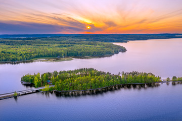 Aerial view of Pulkkilanharju Ridge, Paijanne National Park, southern part of Lake Paijanne. Landscape with drone. Blue lakes, fields and green forests from above on a sunset summer day in Finland.