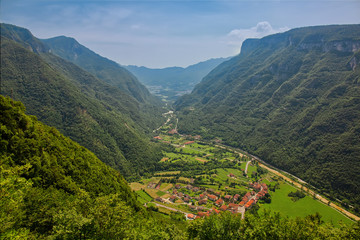 Scenic view to the valley with some settlements, summertime outdoor background