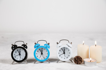 Background with alarm clock and flowers on white.