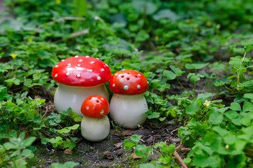 Old fayence mushroom set in a cloverfield - mushroom in red hat with white dots shape porcelain spice racs on white background - vintage mass production object