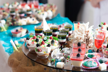 Luxurious desserts and drinks at the buffet table. Shallow depth of field.