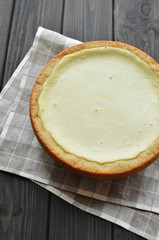 homemade cottage cheese pie on check gray flax napkin background