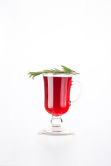 Mulled wine with rosemary in tall glass isolated on white background