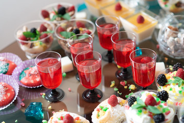 Luxurious desserts and drinks at the buffet table. Shallow depth of field.