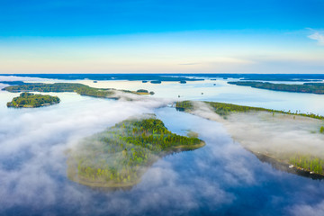 Aerial view of Pulkkilanharju Ridge, Paijanne National Park, southern part of Lake Paijanne. Landscape with drone. Blue lakes, fields and green forests from above on a sunny summer day in Finland.