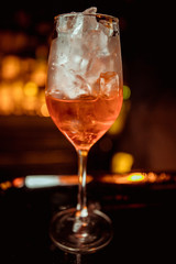 female bartender preparing aperol cocktail in a cocktail bar