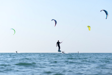 Kite surfer having fun on a beautiful sunny and windy day. Extreme sports and fun. Kitesurfing lessons. Sea and sun. Extreme watersports.