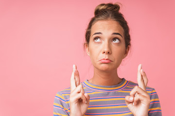 Image closeup of disappointed caucasian woman wearing striped t-shirt looking upward with fingers...