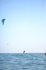 Kite surfer having fun on a beautiful sunny and windy day. Extreme sports and fun. Kitesurfing lessons. Sea and sun. Extreme watersports.