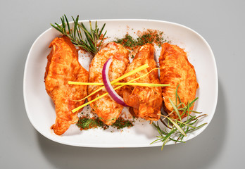 marinated chicken wings on white tray