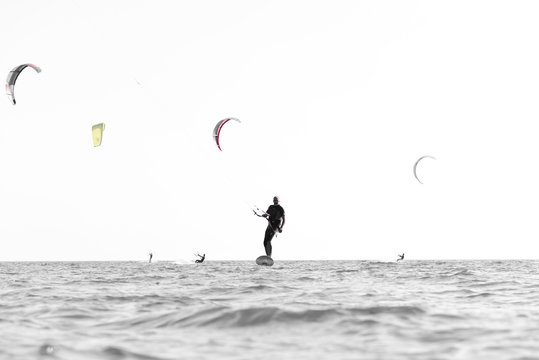 Kite surfer having fun on a beautiful sunny and windy day. Extreme sports and fun. Kitesurfing lessons. Sea and sun. Extreme watersports.