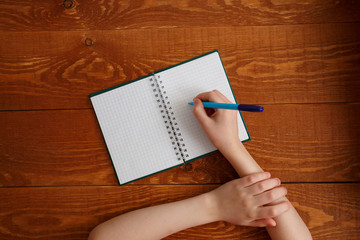 Character Child Writing in Blank Notebook Flat Lay