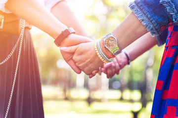 Young women are having fun on the green park in the evening.