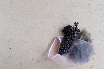 Zero waste food and plastic free shopping concept. Black grape in cotton bag.
