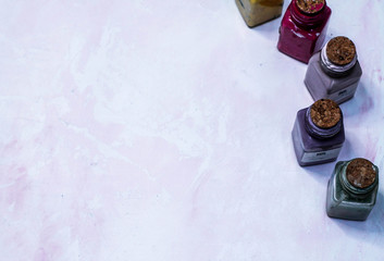  paint bottles on pink background