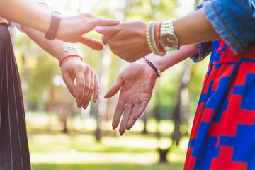 Young women are having fun on the green park in the evening.