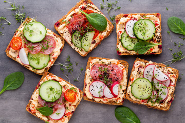 Sandwiches with cream cheese, vegetables and salami.