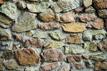The texture of the old masonry. Background image of a stone-lined wall
