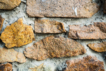 The texture of the old masonry. Background image of a stone-lined wall
