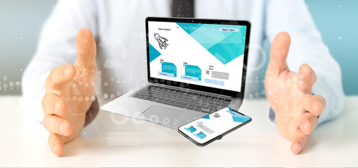 Businessman holding a Laptop and a smartphone - 3d rendering