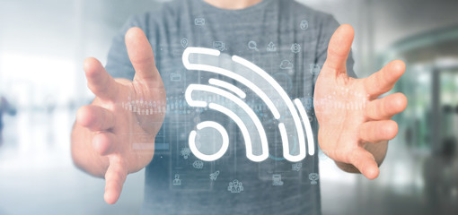 Businessman holding a wifi icon with data all around