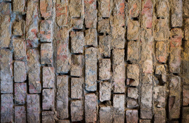 Texture of an old paint covered brick wall. Background image of an abandoned brick wall with painted over paint