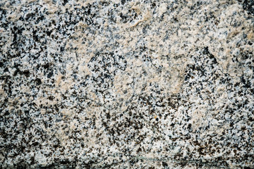 The texture of the stone overgrown with moss. Background image of a boulder