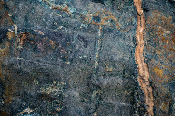 The texture of the stone overgrown with moss. Background image of a boulder