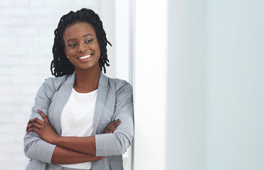 African American Business Girl Smiling At Camera Crossing Hands Indoor