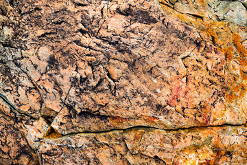 The texture of the stone overgrown with moss. Background image of a boulder