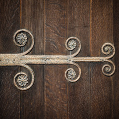 Wrought iron hinge detail on old timber church doors.
