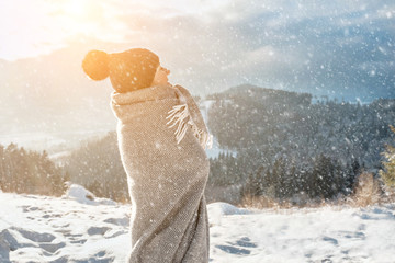 Happy woman traveler on the snowy of mountain look on the nice w