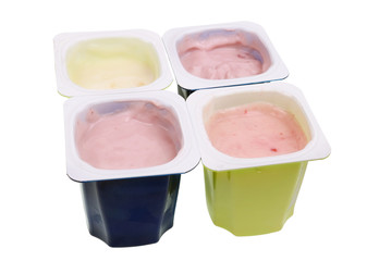 Real cheap nonfat cherry and strawberry yogurt in blue and green open plastic cups  isolated macro