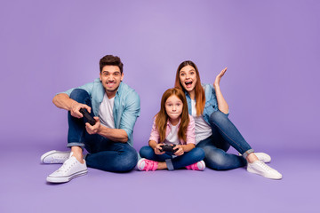 Photo of three family members sitting floor trying hard to win team game wear casual clothes...