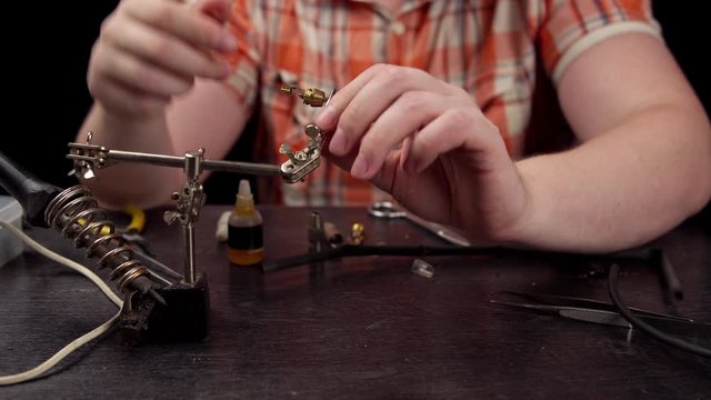 Process of replacing cable for audio rca connector. Muscled electrician solder wire with rosin soldering iron to male jack rca.