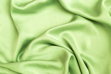Abstract green satin fabric texture background