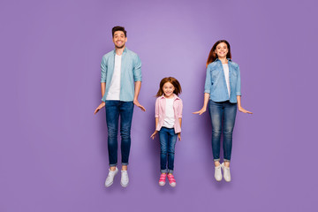 Obraz premium Full size photo of three jumping high family members wear casual clothes isolated purple background