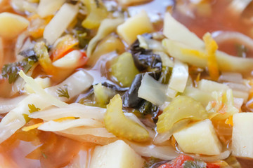 Weight loss celery and cabbage dietary Bonn soup in white vintage plate on handmade knitted napkin