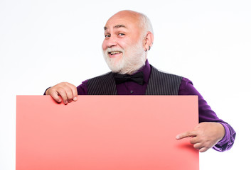 Senior means experienced. Senior man recommend something. Senior holding blank sign board and looking at camera. Elderly people. Man bold head and gray beard hold poster for advertisement copy space