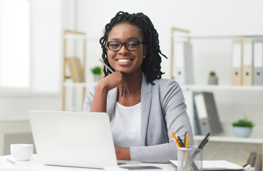 Afro Business Lady Smiling At Camera Sitting At Laptop