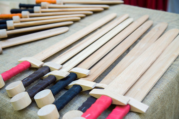 Handmade wooden toy swords at souvenir market